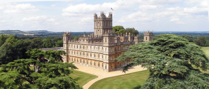 the view of highclere castle which was used as the setting for downtown abbey seen on a guided coach tour of downtown abbey