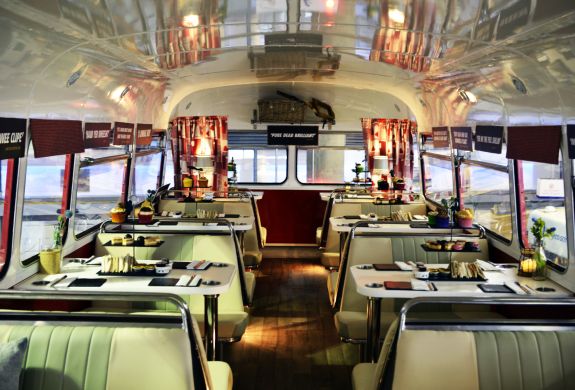 the interior of the red bus bistro set up for afternoon tea
