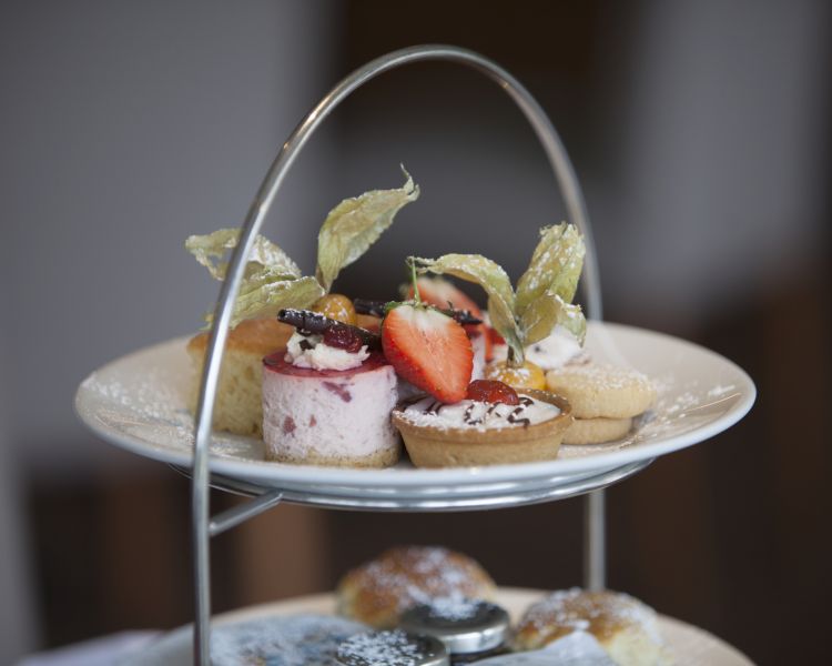 a close up of the cakes for an afternoon tea at a country house hotel in hertfordshire