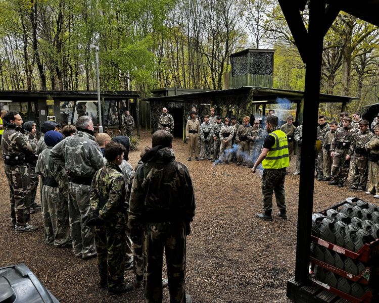 large group of people listening to a marshall before a paintball experience