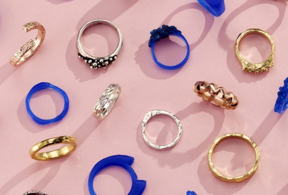 a selection of gold and silver rings and their wax ring models shown as examples of what you can make on a ring making experience