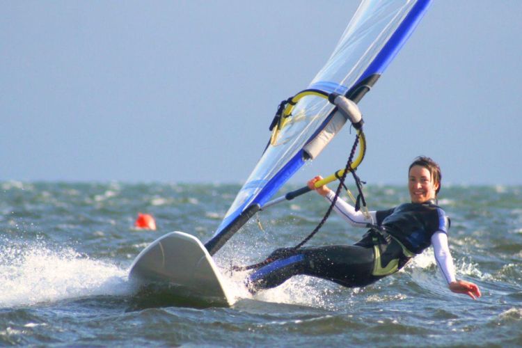 Woman windsurfing in the sea