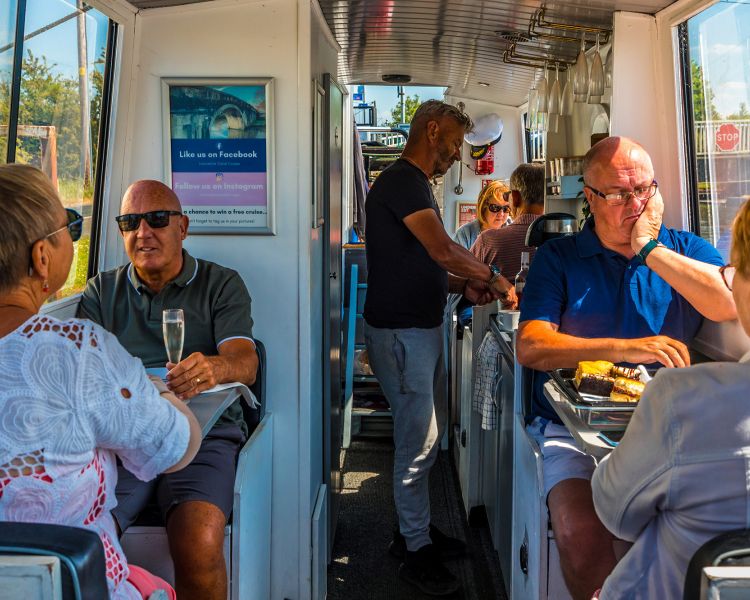 People eating on a canal boat