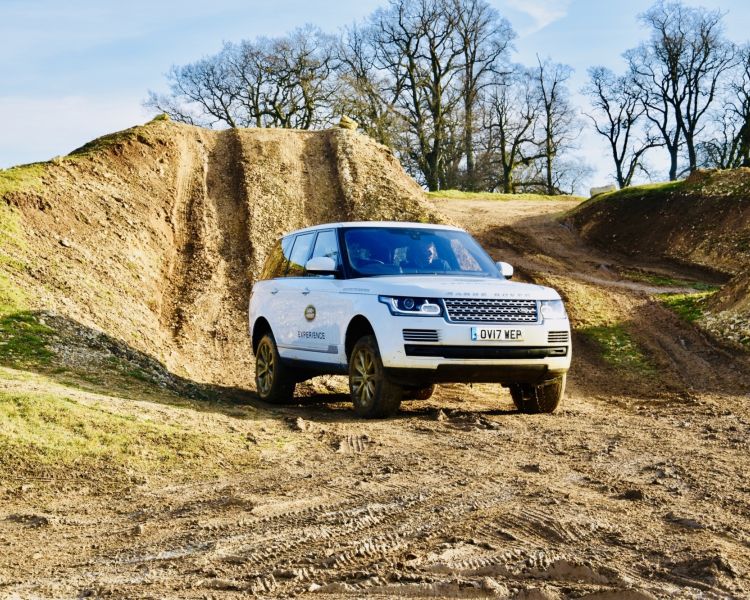 land rover in middle of muddy track for off road driving experience