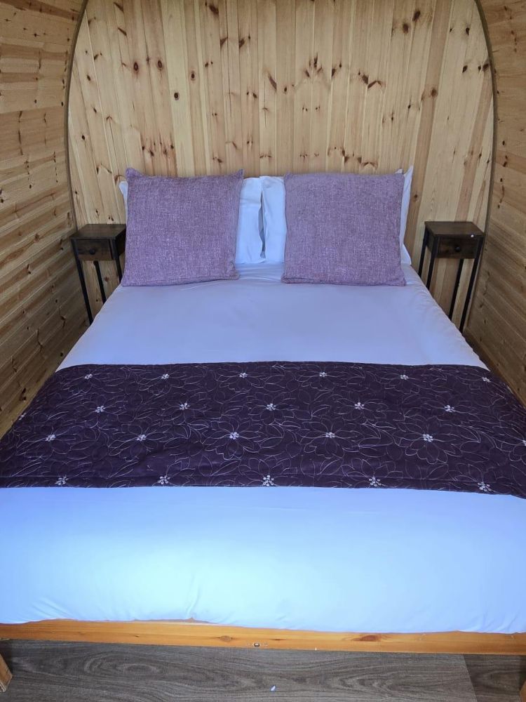 inside a glamping pod showing a double bed for a stonehenge unique stay