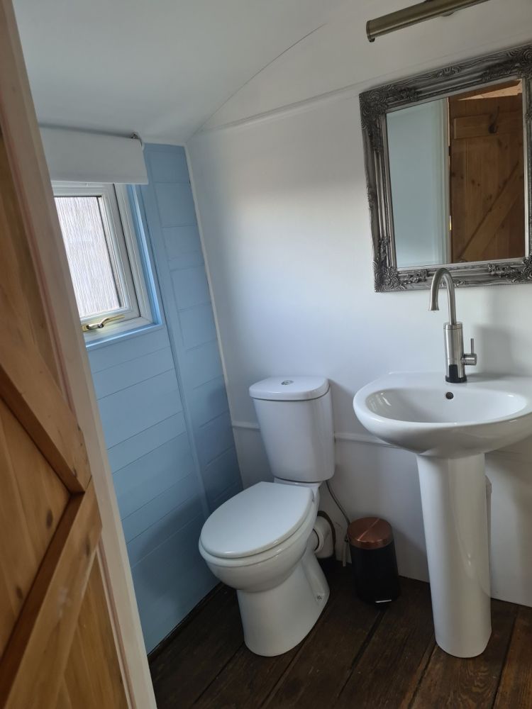 The bathroom with toilet inside the railway carriage used for short stays near stonehenge