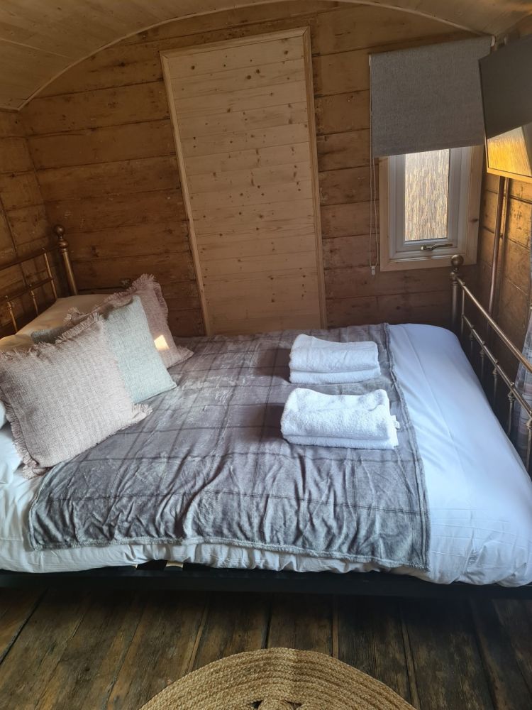 The double bed inside the railway carriage used for short stays near stonehenge