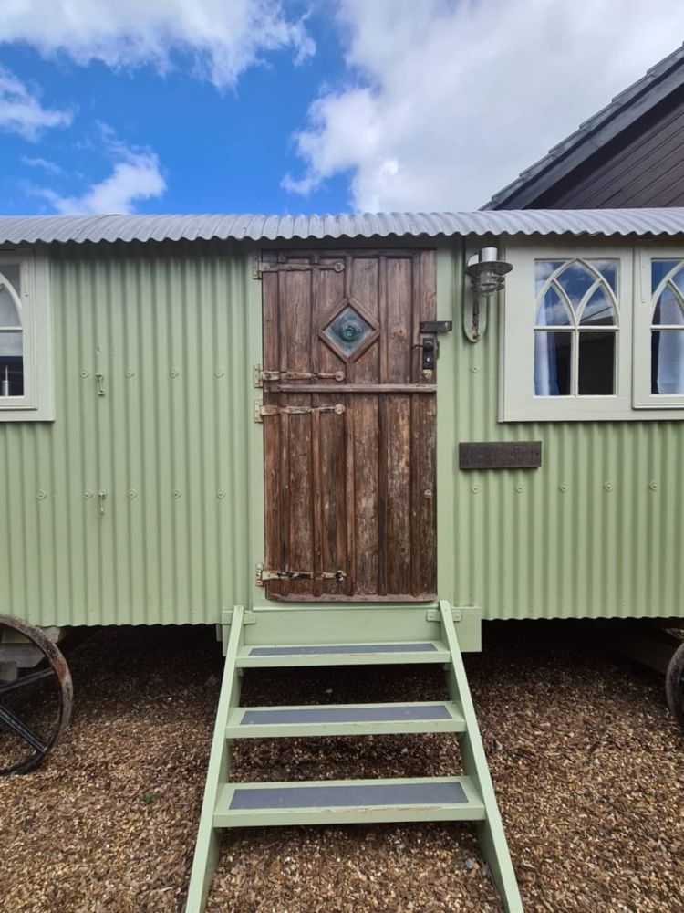 Front of the shepherds hut painted sage green used for short stays near stonehenge