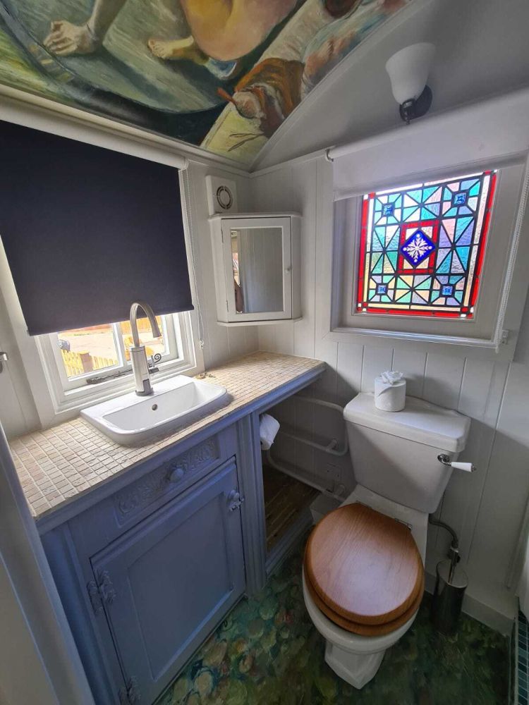 The bathroom with toilet inside the shepherds hut used for short stays near stonehenge