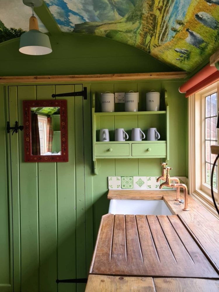 The kitchen area with tea and coffee making facilities inside the shepherds hut used for short stays near stonehenge