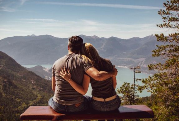 Couple sat in front of mountain view