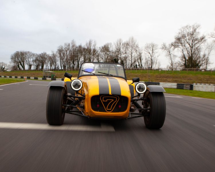 a caterham seven on the race track for a driving experience