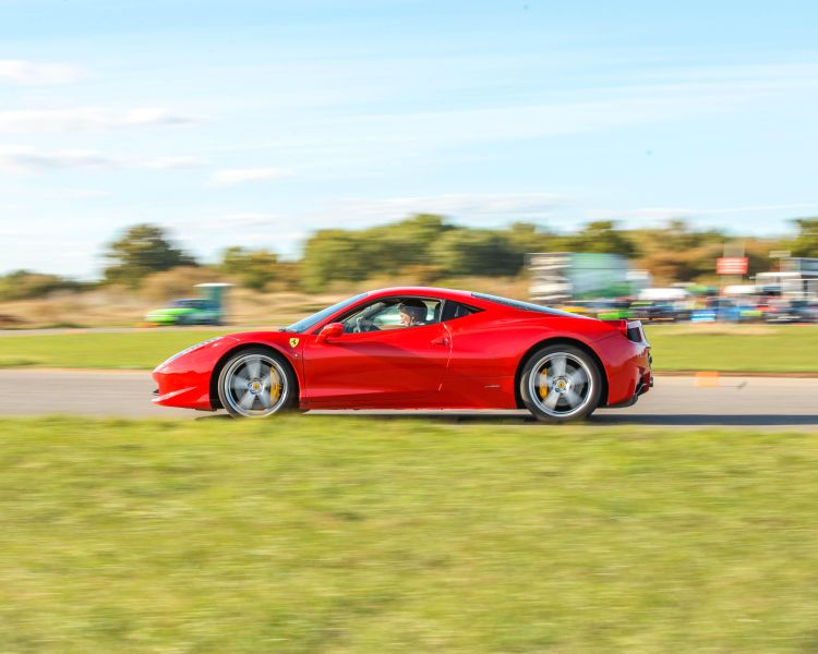 a red ferrari on a race track for a driving experience day