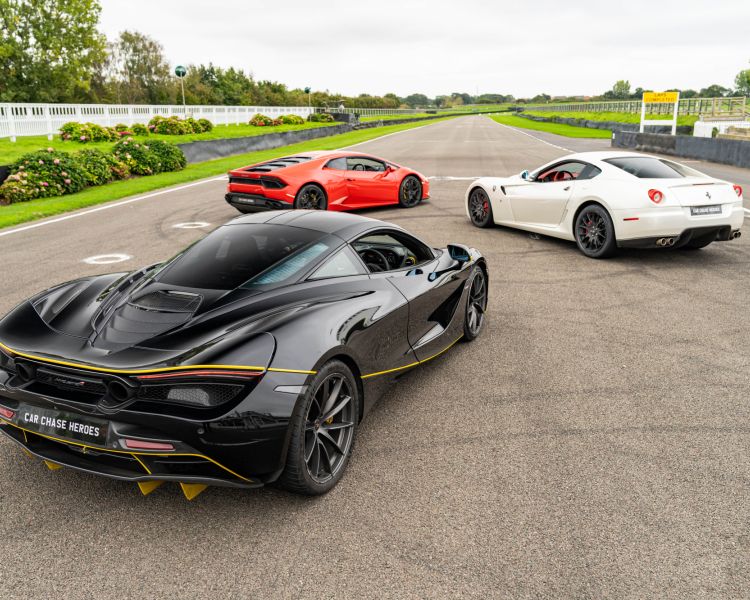 three supercars seen from the back on a race track for a driving experience