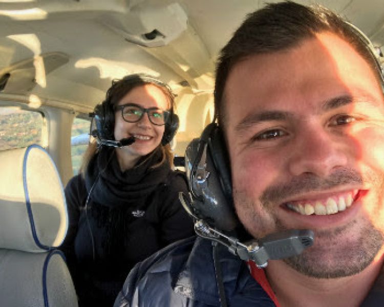 Man and woman sitting in a helicopter for a helicopter flying lesson