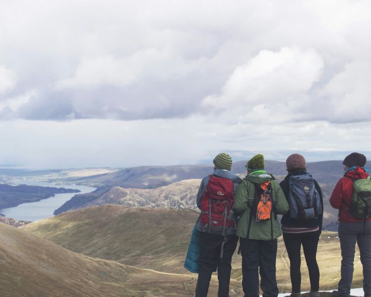 Person standing on top of a hill in the lake district