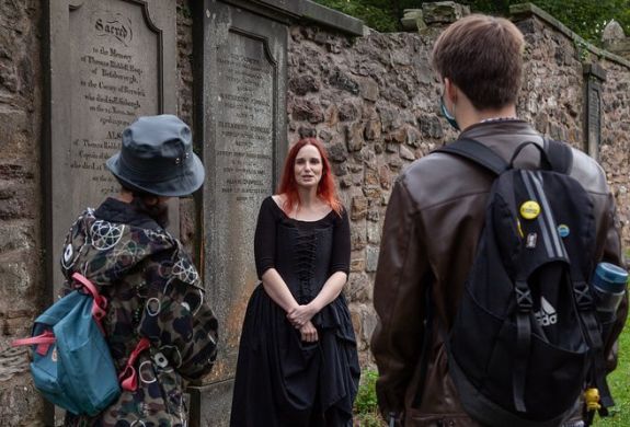 Guide talking to group on a vaults and graveyard walking tour in edingburgh