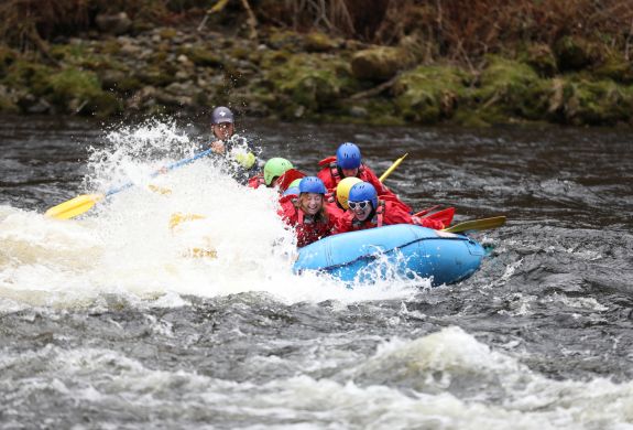 people white water rafting on the river tay in scotland