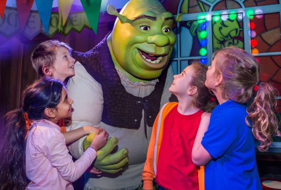group of children meeting shrek as part of the shrek adventure experience in london