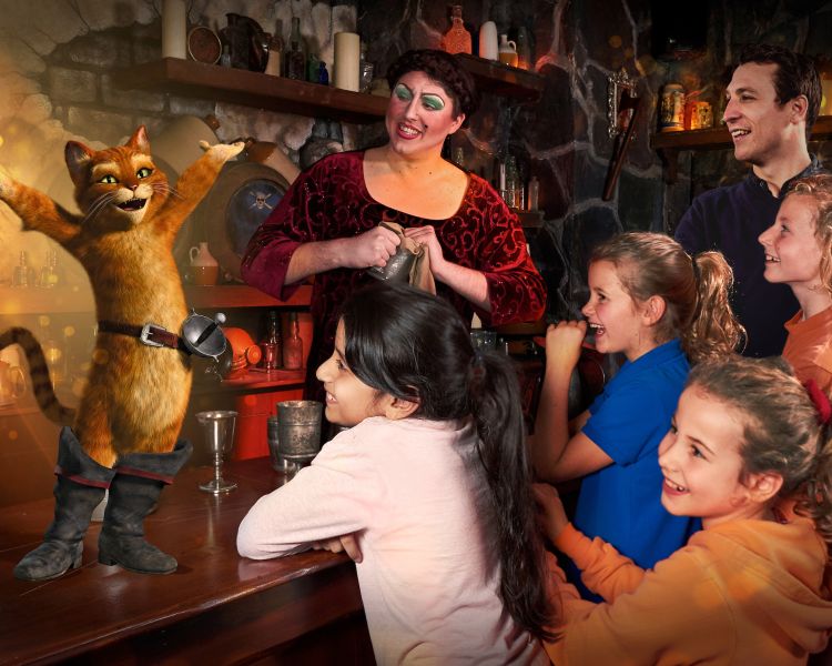 family group enjoying a visit to the poison apple bar as part of the shrek adventure experience in london