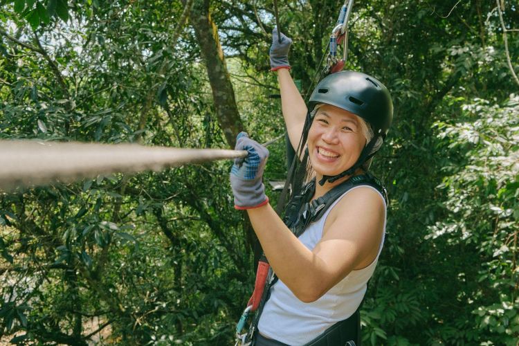 Woman on a zip line in trees