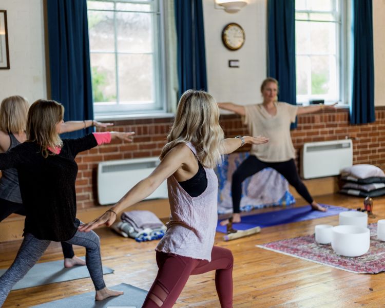 women at a yoga class on a mindfulness day retreat experience
