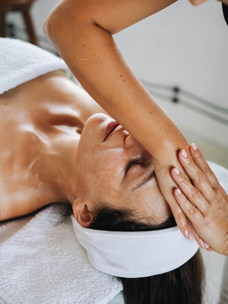 woman having a facial pressure point treatment
