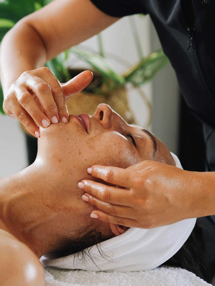 woman having a pressure point facial treatment