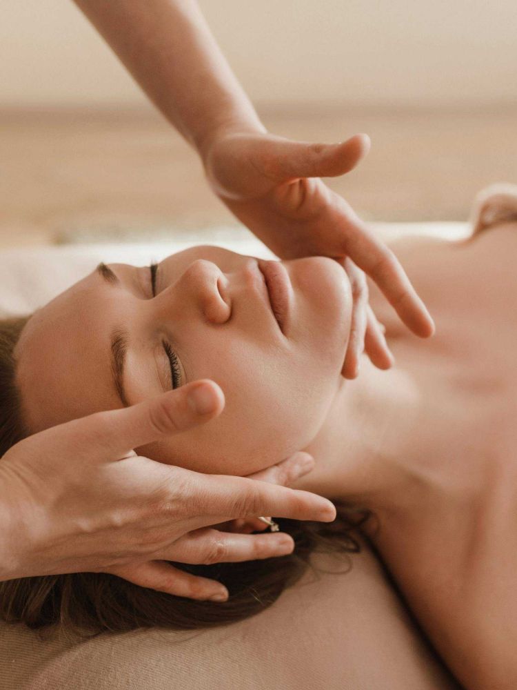 woman having a pressure point facial treatment