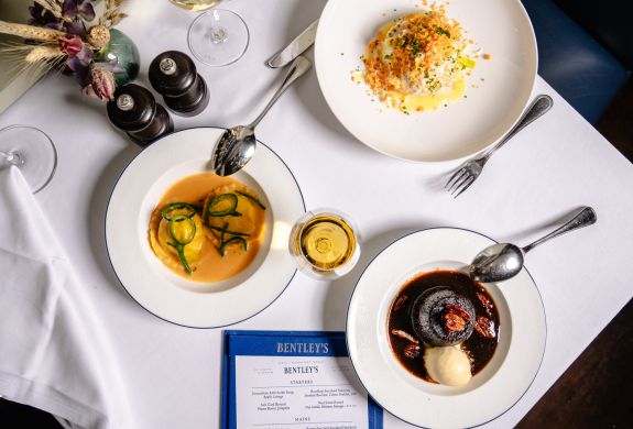 a table laid out for a seafood dining experience at bentley's mayfair