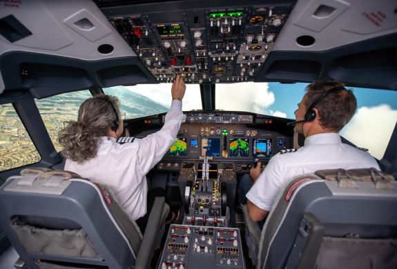 man and woman in the cockpit of a boeing 737 flight simulator at luton airport