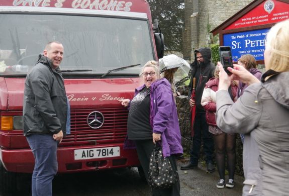 People having photo infront of daves coach on gavin and stacey tour