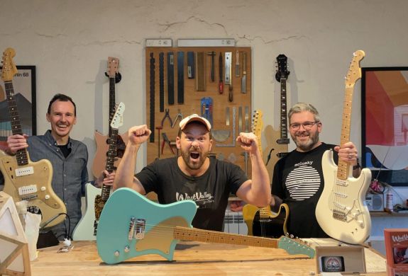 3 men holding guitars