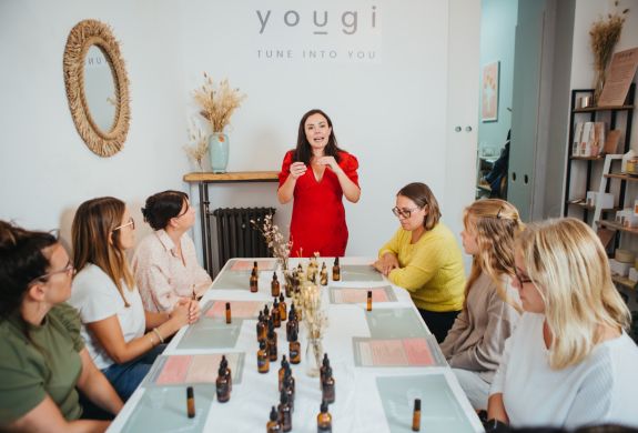 host talking to the group on a perfume making workshop in london