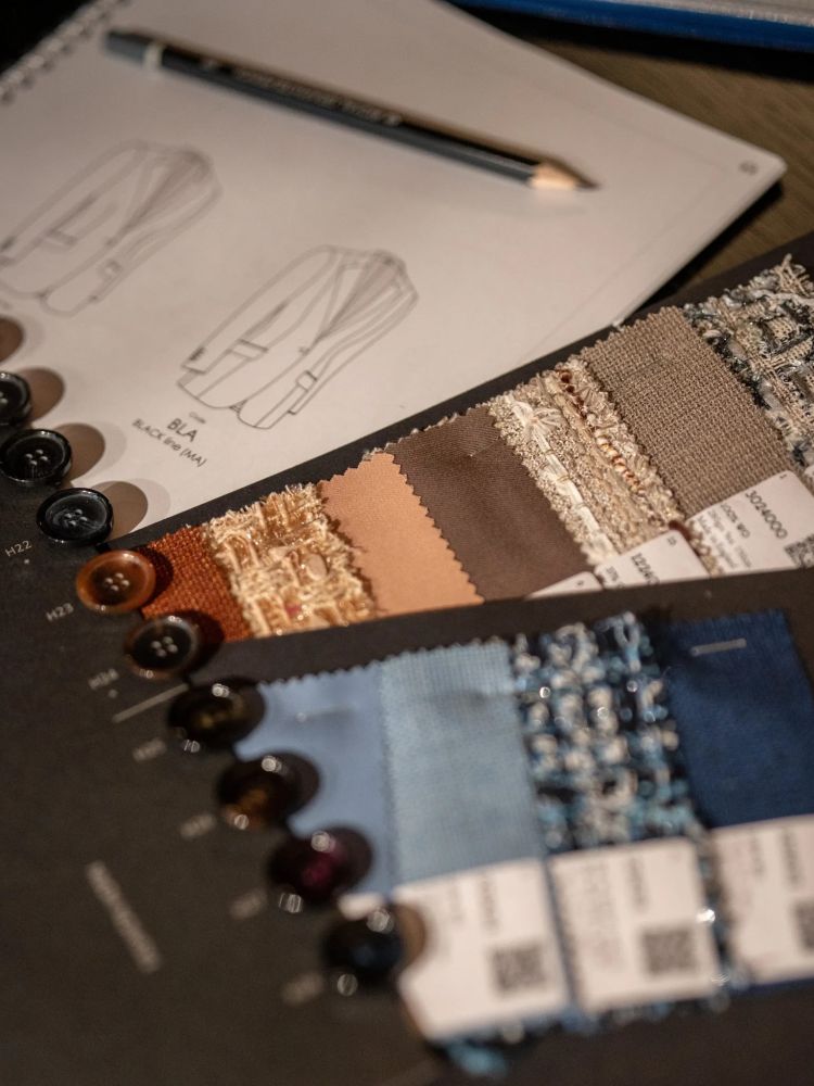 fabric swatches and design notes at a savile row design studio in london