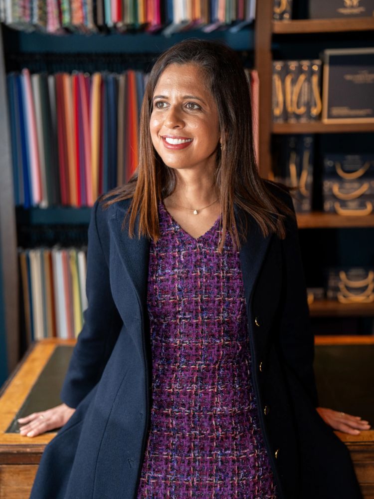 woman wearing a bespoke coat designed and made in savile row london