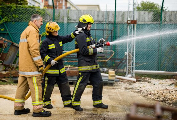 Holding a water hose firefighter experience min