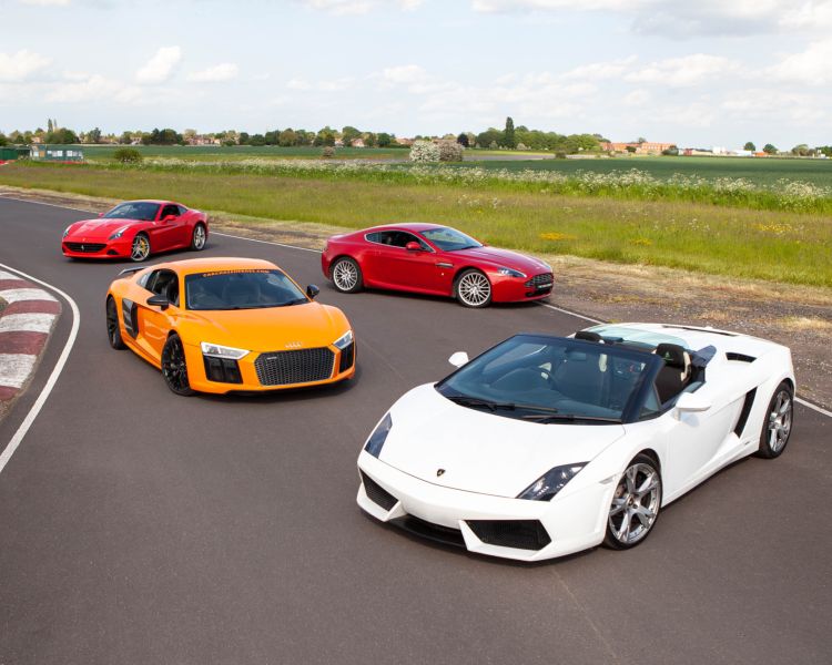 four supercars on a race track for a driving day experience