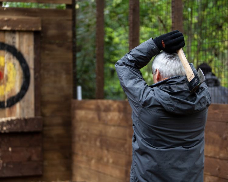 man throwing axe at go ape axe throwing experience