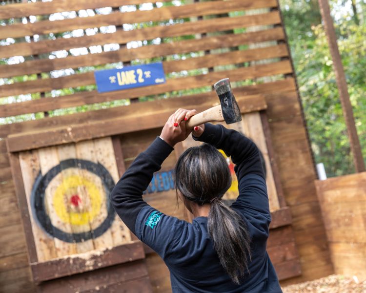 girl about to throw axe at go ape axe throwing experience