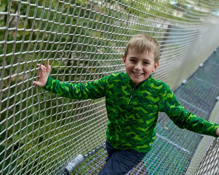 young boy in net tunnel at go ape nets adventure