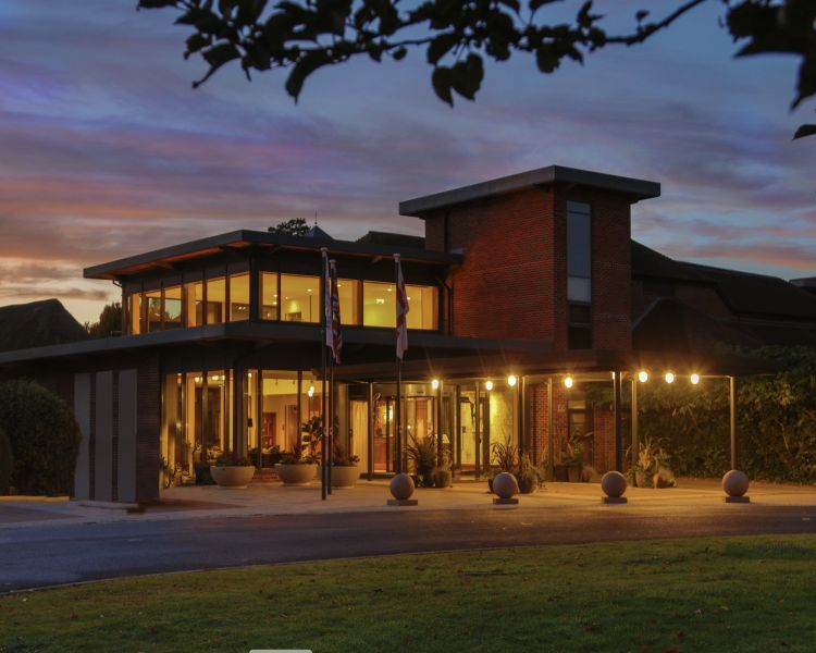 the exterior of q hotels norton park lit up at night