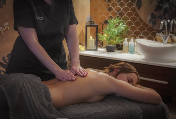 woman having massage treatment at q hotels dunston hall in norfolk
