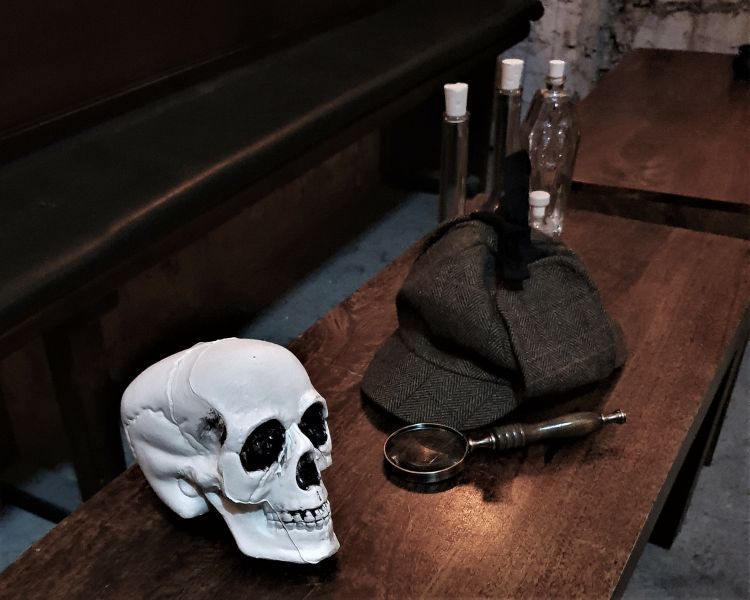 a white skull and dearstalker hat on a table as part of a sherlock holmes experience in edinburgh