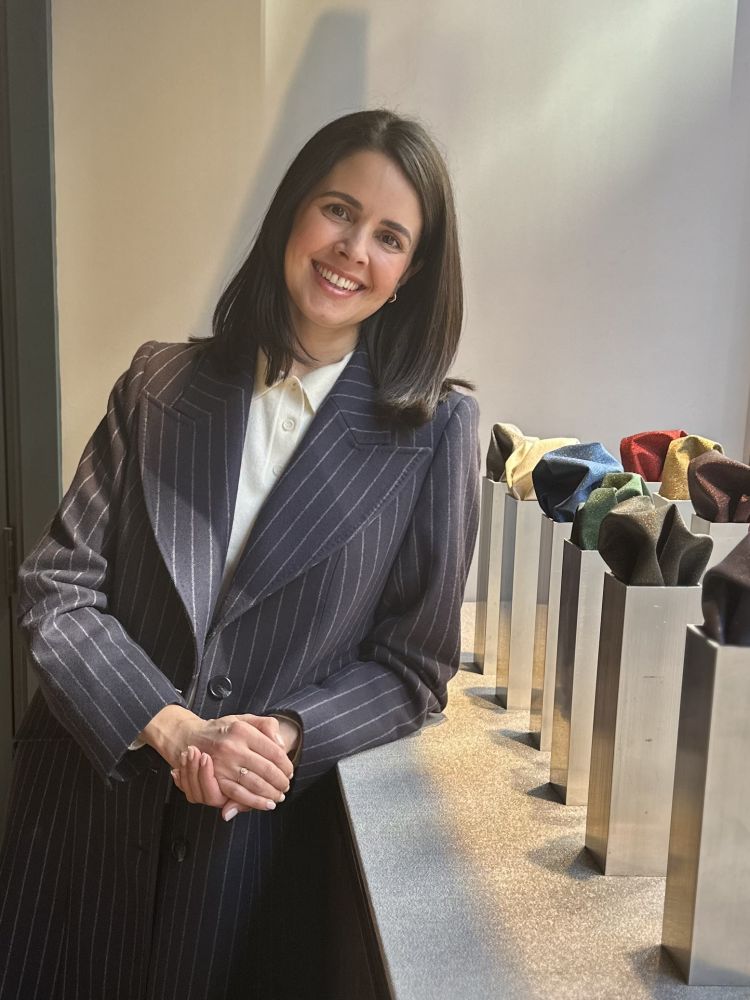 Woman wearing coat tailor made by nooshin on savile row london