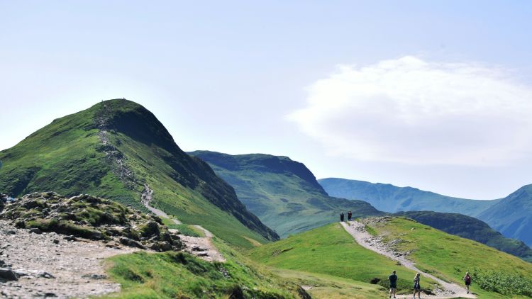 People walking up cat bells in the lake district on a north west short break
