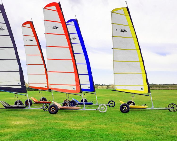 five land yachts in a group on grass for a land yachting for groups experience day