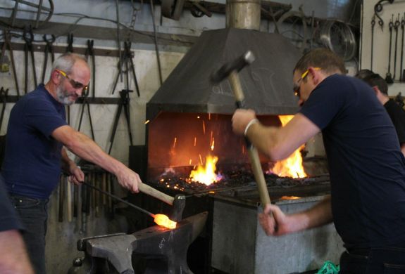 Man hitting hot metal to make an axe head