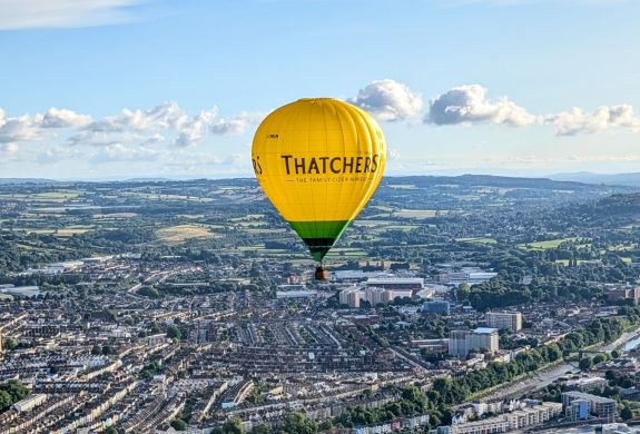 Hot air balloon flying over city of bristol