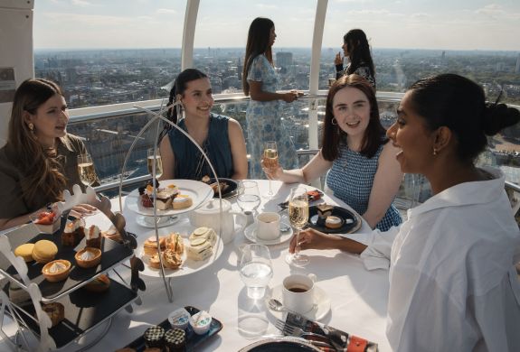 girls having afternoon tea in a london eye pod